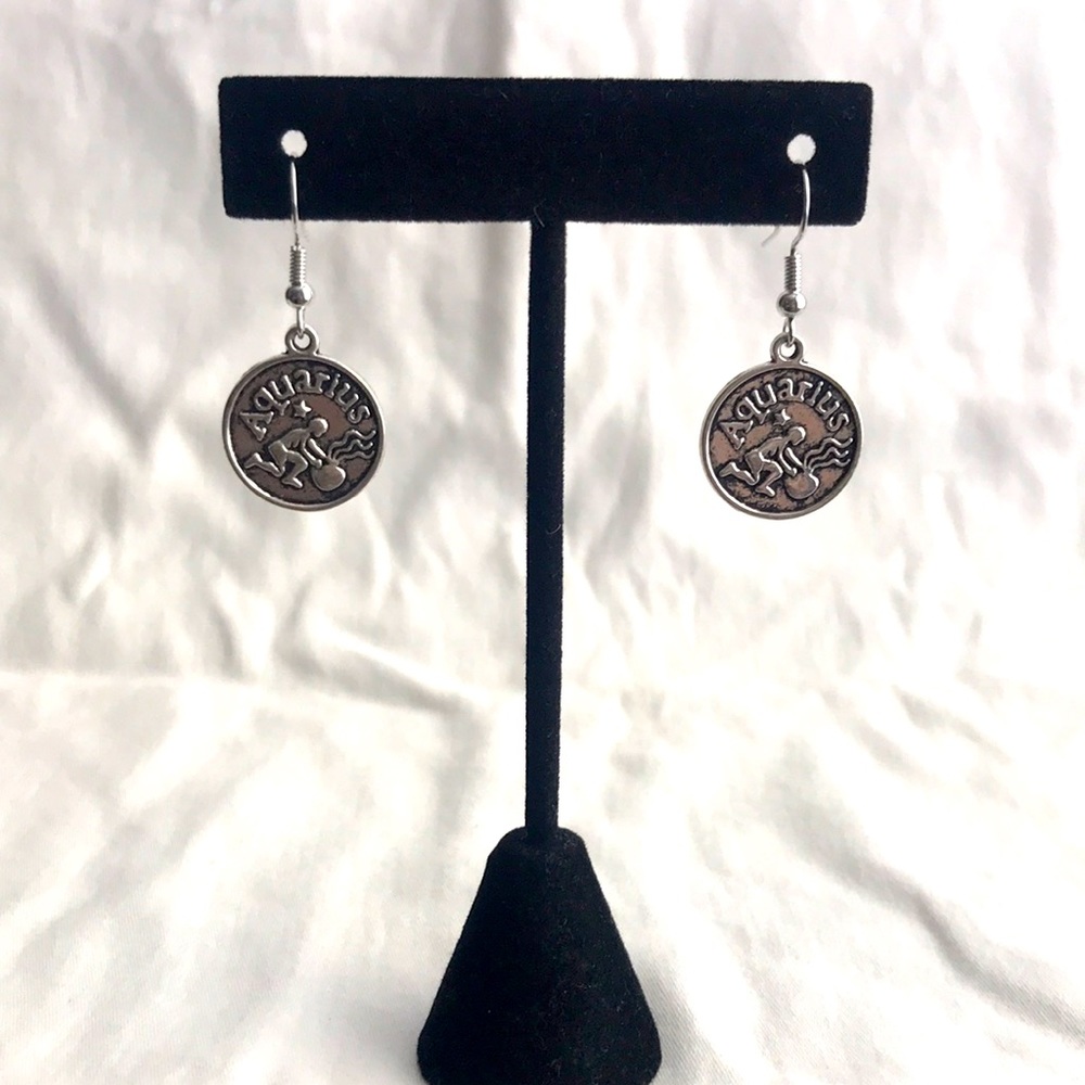 Silver tone AQUARIUS earrings.